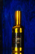 Gold bottle with a label against a blue background